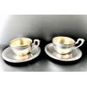 Pareja de tazas y platos de café de plata.