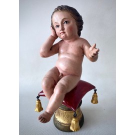 Infant Jesus sitting. Polychrome and golden carving.  First half of the 18th century.